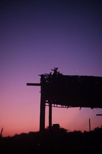 Low angle view of silhouette structure against sky at dusk