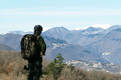 Rear view of people looking at mountains