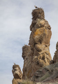 Low angle view of rock formation against sky