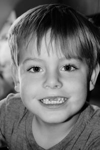 Portrait of smiling boy with gap toothed at home
