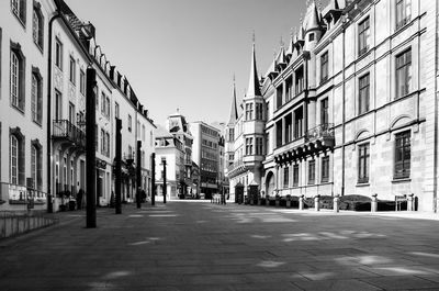 View of city street and buildings against sky