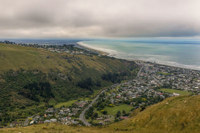 High angle view of sea and cityscape against sky