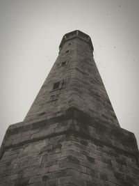 Low angle view of clock tower against sky