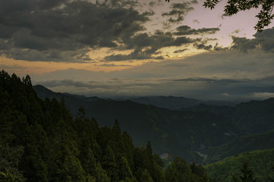 Scenic view of mountains against sky at sunset