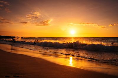 View of calm beach at sunset