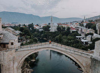 Arch bridge over river in city