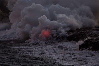 Scenic view of sea against storm clouds