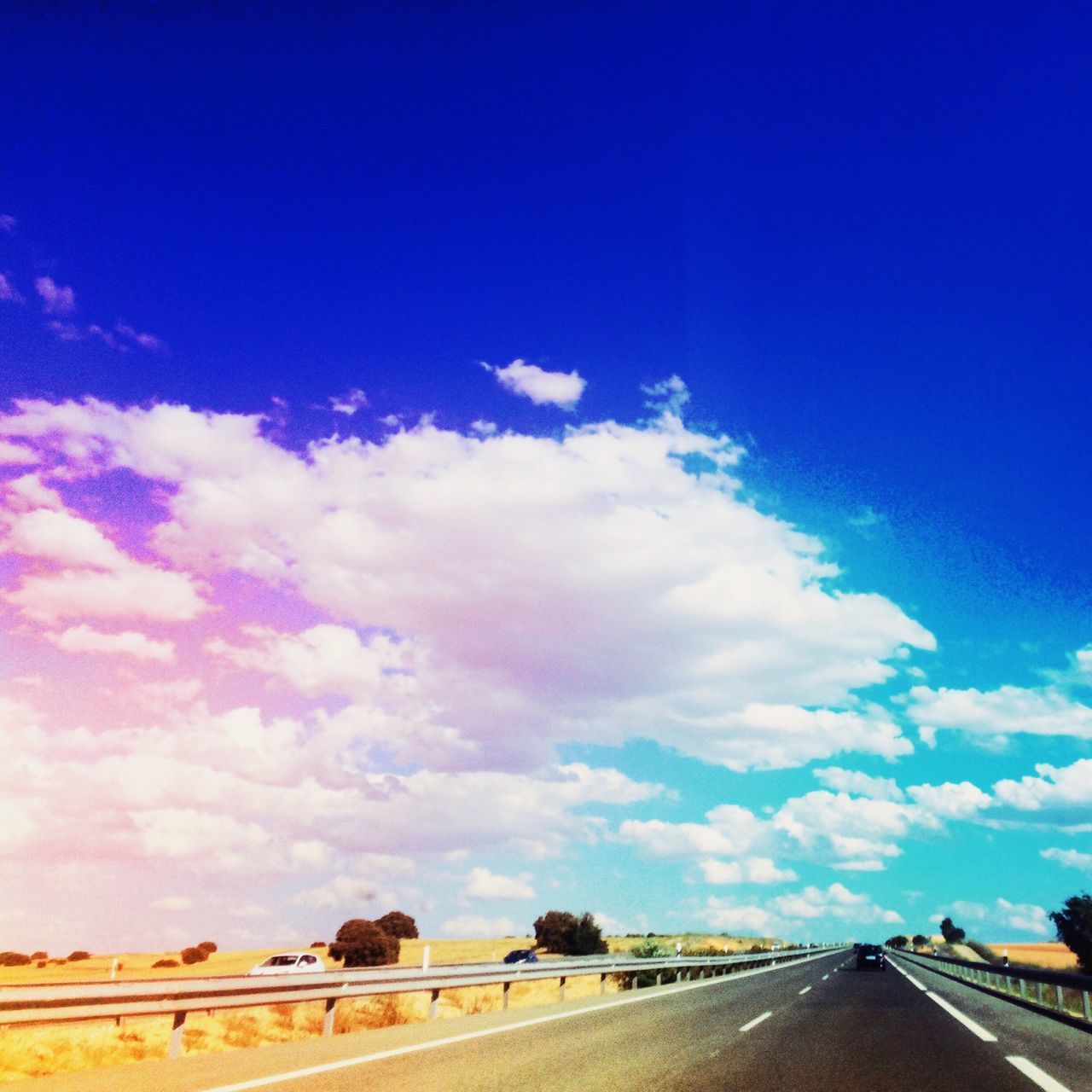 sky, transportation, blue, the way forward, cloud - sky, road, cloud, diminishing perspective, railroad track, vanishing point, nature, road marking, cloudy, tranquility, landscape, outdoors, rail transportation, railing, no people, scenics