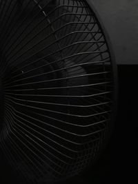 Close-up of electric fan against black background