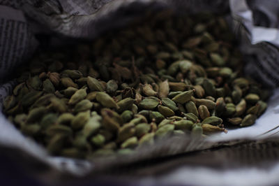 Close-up of cardamoms in paper bag