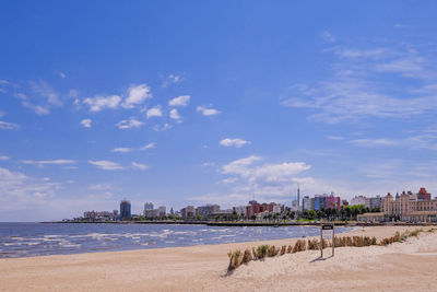 Sea and buildings against sky