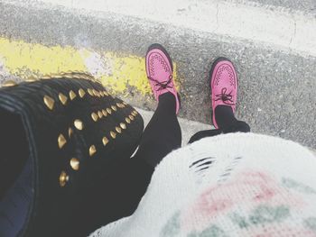 Low section of person standing on road