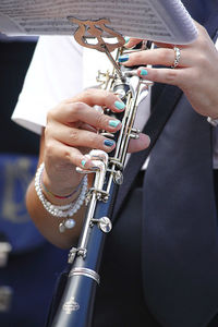 Midsection of woman playing saxophone