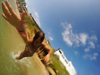 Woman jumping into sea