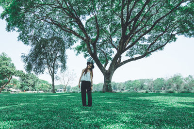 Man standing by tree on field