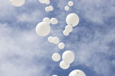Low angle view of balloons against sky