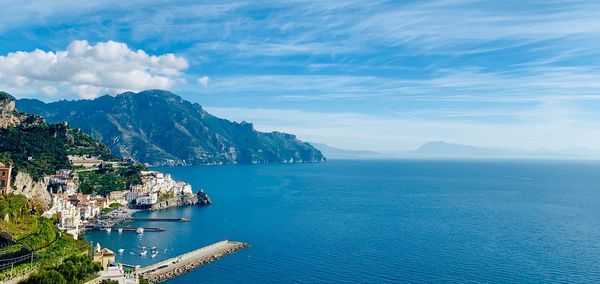 Scenic view of sea and mountains against sky