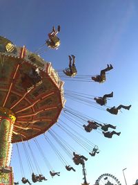 Low angle view of ferris wheel against blue sky