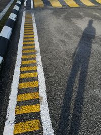 High angle view of yellow crossing sign on road