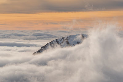 Scenic view of volcanic mountain against sky during sunset