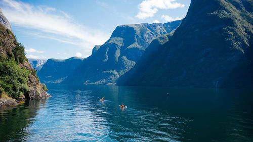 Scenic view of lake and mountains against sky