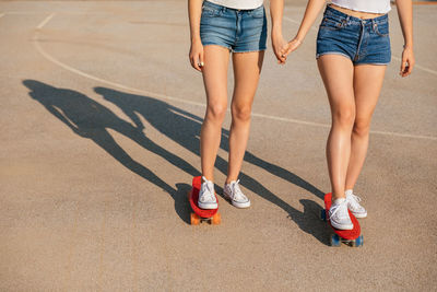 Two teenage sisters skating together