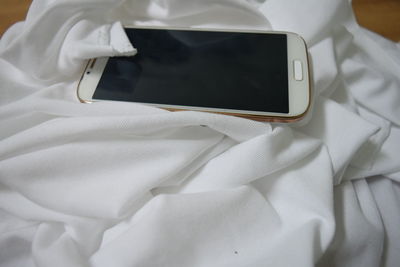Smart phone on white fabric 
