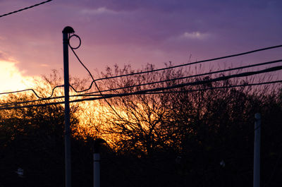 Silhouette of street light against sky at sunset