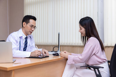 Doctor examining patient in clinic