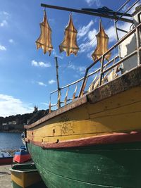 Sailboats moored on sea against sky