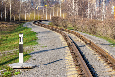 Railroad tracks amidst trees in forest