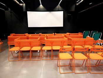 Empty chairs and tables in room