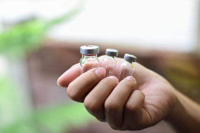 Close-up of woman hand holding bottle