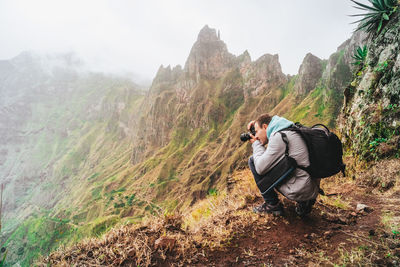 Man photographing on mountain