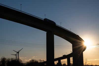 Low angle view of bridge against sky during sunset