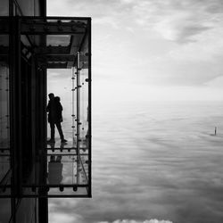 Silhouette man standing in front of building