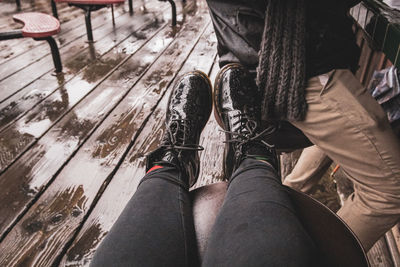 Low section of man sitting on wooden floor