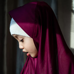 Close-up portrait of a young woman looking away