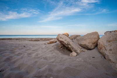 Rocks on beach against sky