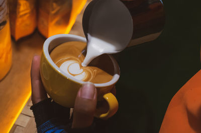 Close-up of hand holding coffee cup