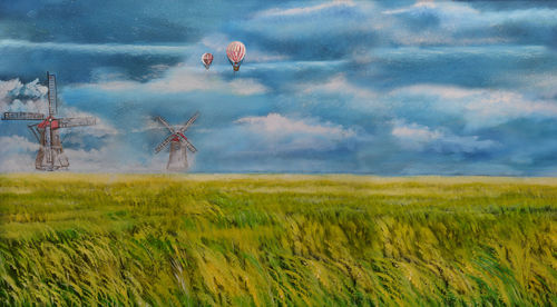 Scenic view of agricultural field against sky