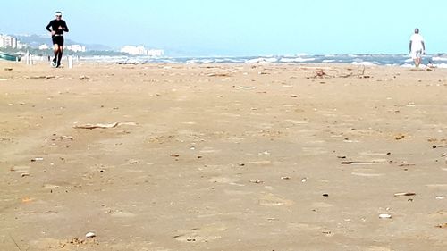 Rear view of people on beach