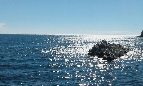 Scenic view of sea against clear blue sky