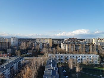 High angle view of road by buildings against sky