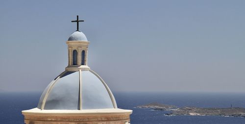 Traditional greece church by sea against sky