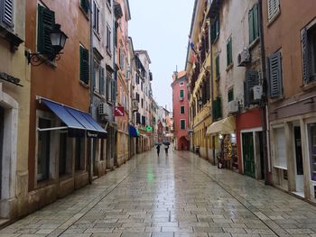 Narrow street amidst buildings in city