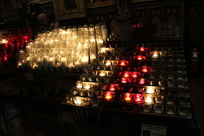 Illuminated candles in temple building