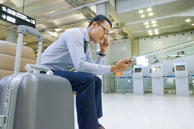 Full length of senior man using mobile phone