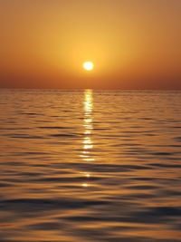 Scenic view of sea against romantic sky at sunset