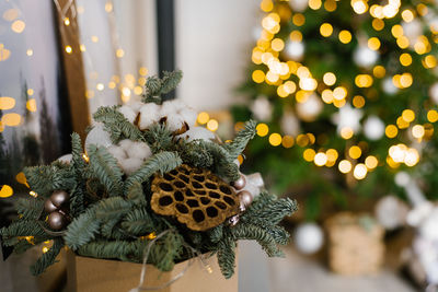 Christmas composition of fir branches, christmas balls and cotton bolls. selective focus.